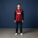 Male model wearing the Kaká #22 AC Milan style full-sleeve football jersey in iconic red and black stripes with bwin sponsor logo